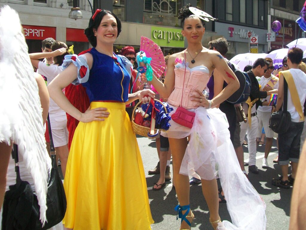 Disney Dunked On For Mustachioed, Dress-Wearing Male ‘Godmother’s Apprenctice’ Disney Drag Queen