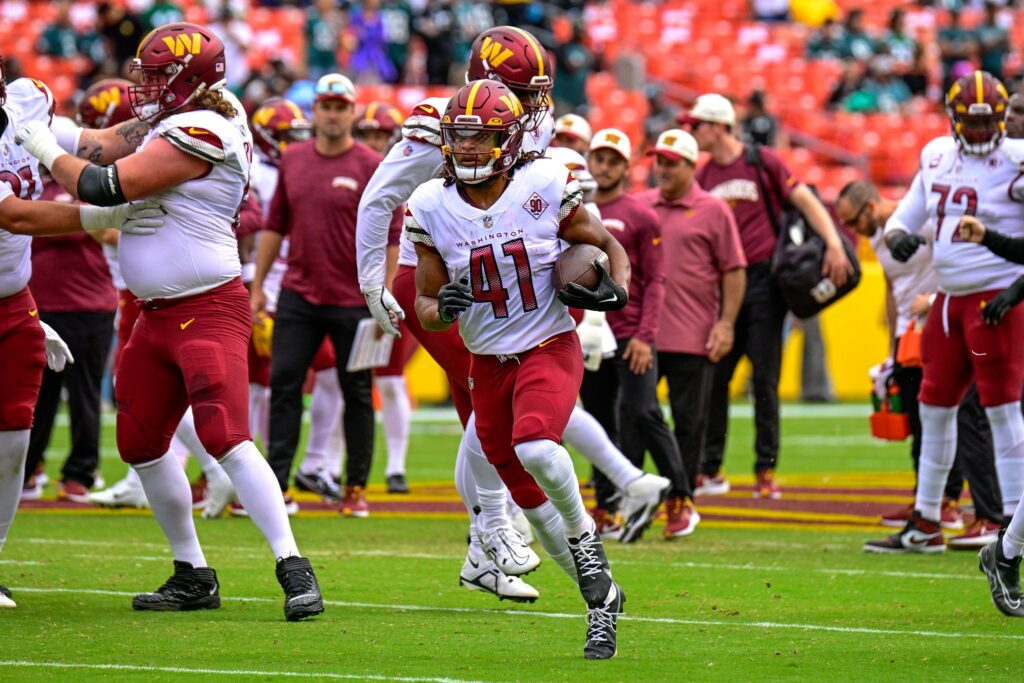 The President Drops Hammer On ‘Woke’ Sports Teams Washington Commanders player rushing
